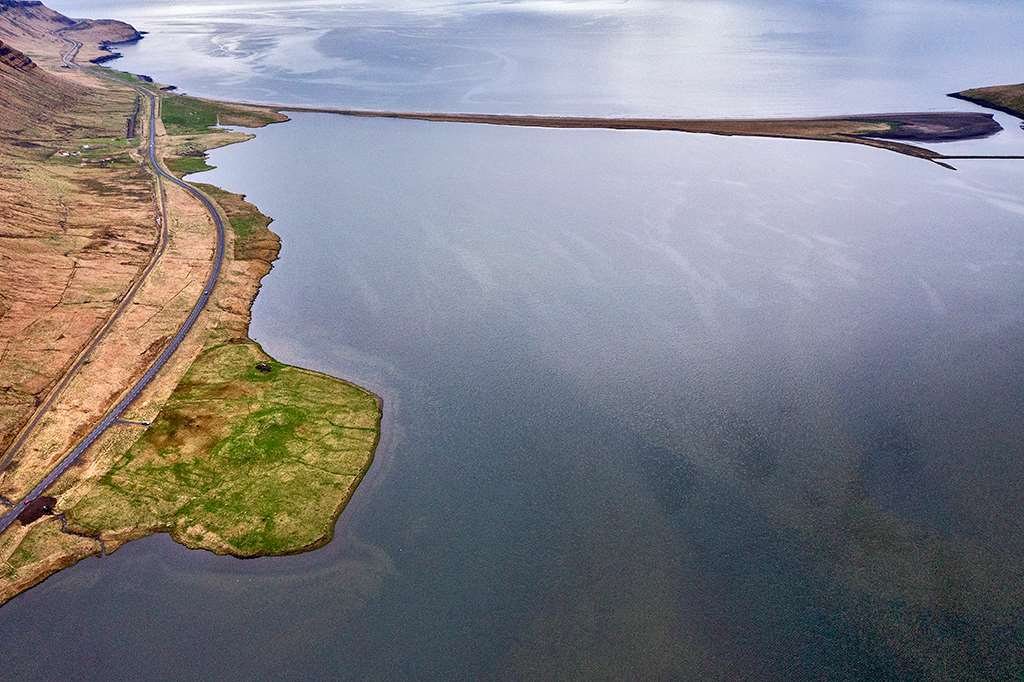 The western part of Lárvaðall from the air, Skerðingsstaðir at lower left and the dammed Lárós outlet at top right; the coves along the south shore are where the ducks gather.